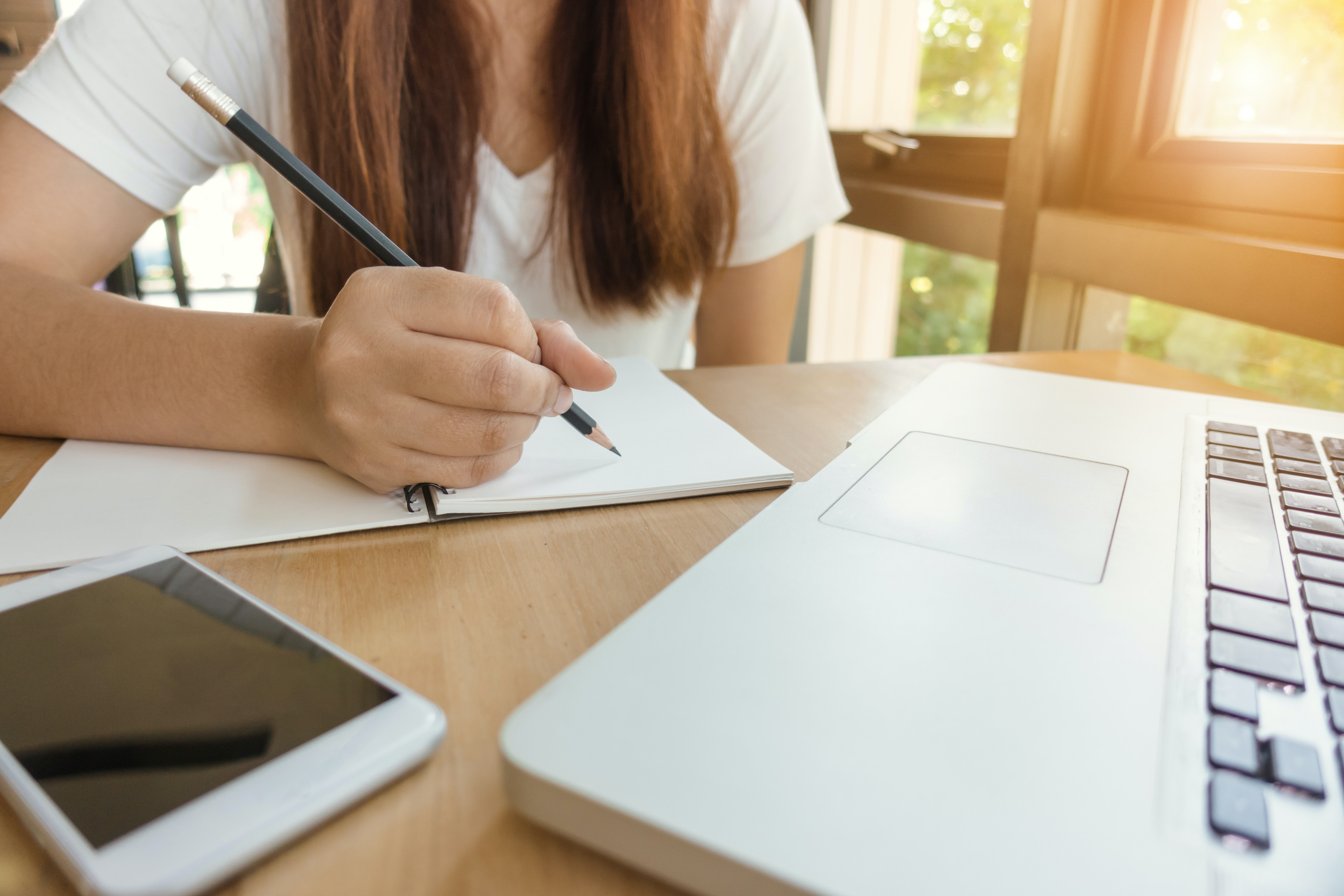 student with a laptop on a desk